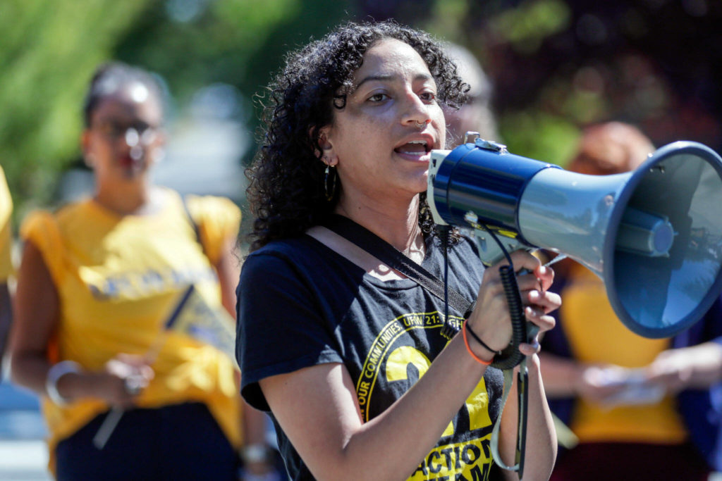 Evelyn Orantes-Fogel starts the rally Wednesday afternoon, in Everett. (Kevin Clark / The Herald)
