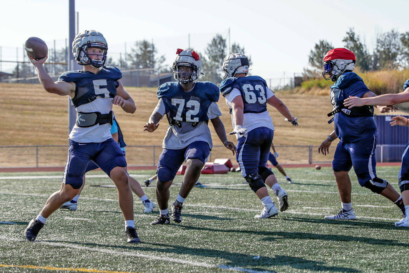 Glacier Peak’s River Lien draws back to pass during practice Thursday afternoon at Glacier Peak High School in Snohomish, Washington on August 25, 2022.  (Kevin Clark / The Herald)