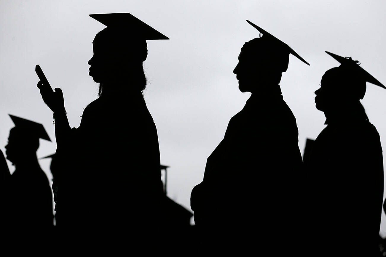 FILE - In this May 17, 2018, file photo, new graduates line up before the start of the Bergen Community College commencement at MetLife Stadium in East Rutherford, N.J.  There’s no single policy or action that will alleviate America’s $1.74 trillion student loan debt crisis while simultaneously preventing students from taking on unaffordable amounts of future debt. Higher education financing experts are divided on the exact combination of solutions, but all agree it will require a multipronged approach.  (AP Photo/Seth Wenig, File)