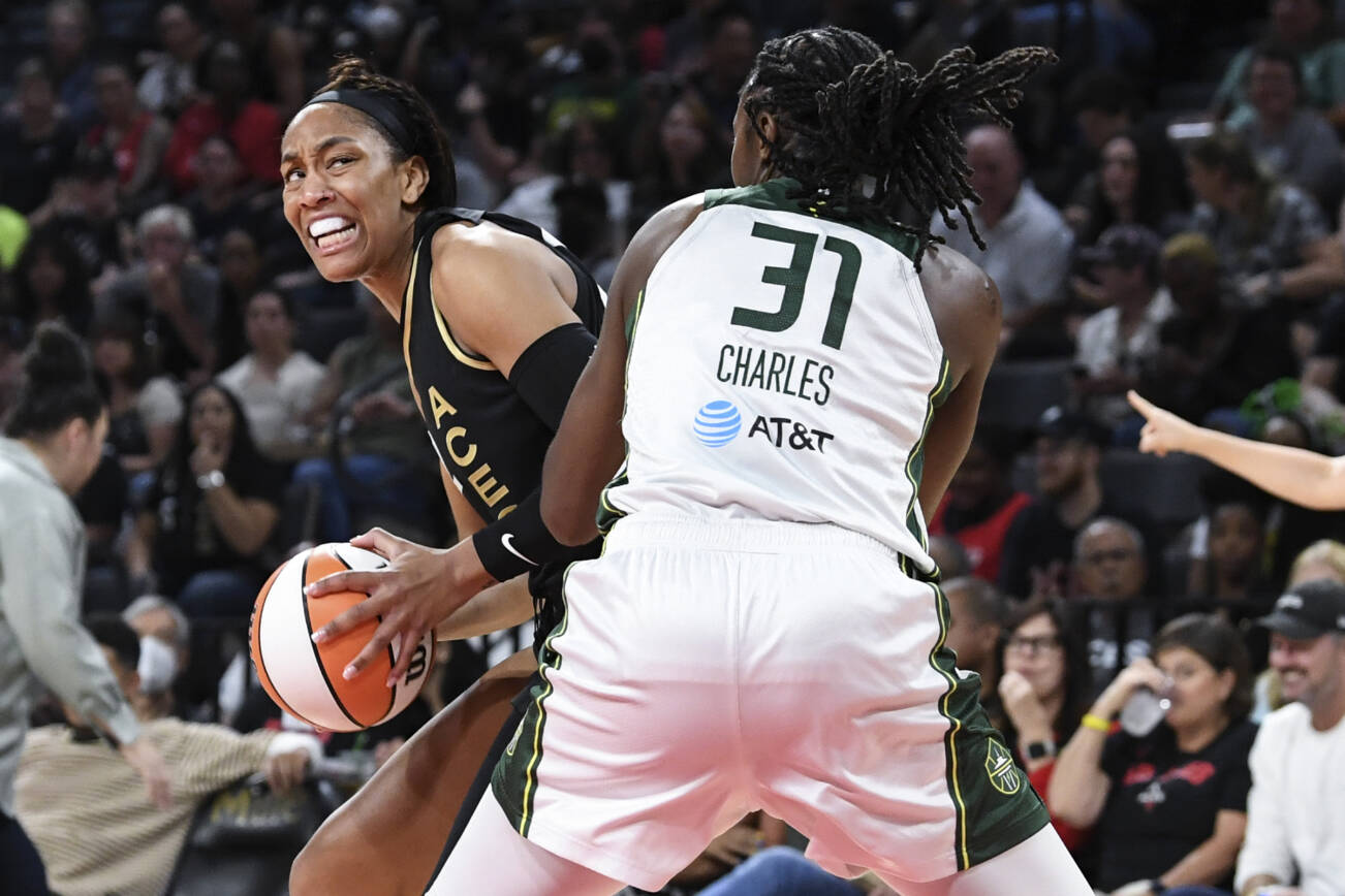 Las Vegas Aces forward A'ja Wilson, left, looks to shoot past Seattle Storm center Tina Charles (31) during the first half of a WNBA basketball game Sunday, Aug. 14, 2022, in Las Vegas. (AP Photo/Sam Morris)