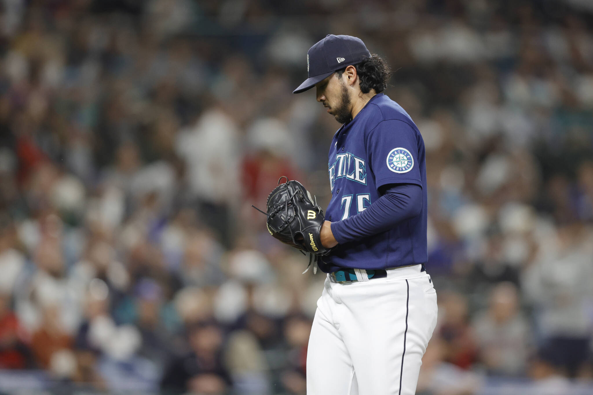 Mariners relief pitcher Andres Munoz walks off the field after giving up three runs and the lead to the Guardians during the eighth inning of a game Saturday in Seattle. (AP Photo/John Froschauer)