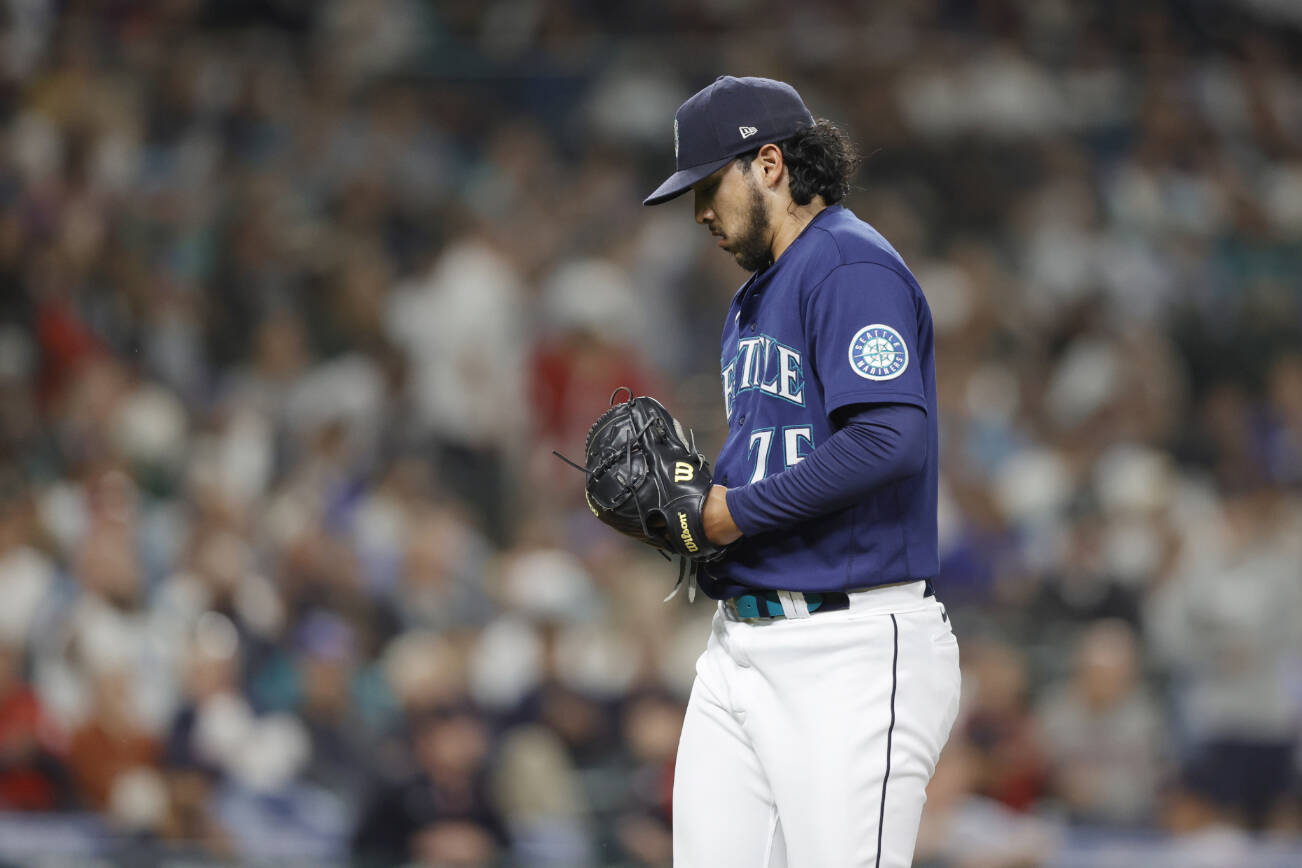 Seattle Mariners relief pitcher Andres Munoz walks off the field after giving up three runs and the lead to the Cleveland Guardians during the eighth inning of a baseball game, Saturday, Aug. 27, 2022, in Seattle. (AP Photo/John Froschauer)
