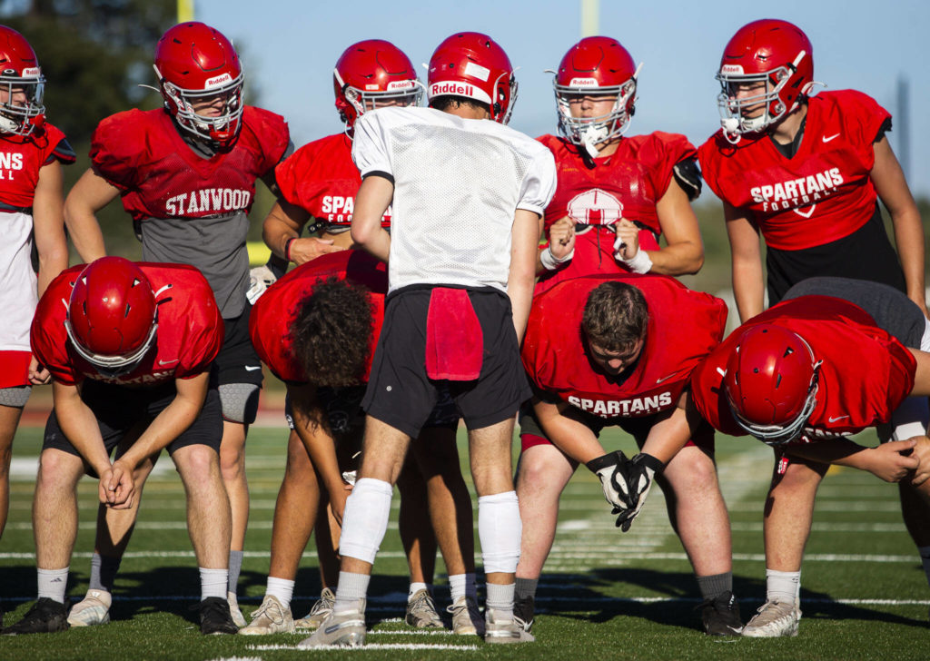 Stanwood’s Michael Mascotti relays the next play to his teammates during practice Monday, Aug. 29, 2022 in Stanwood. (Olivia Vanni / The Herald)
