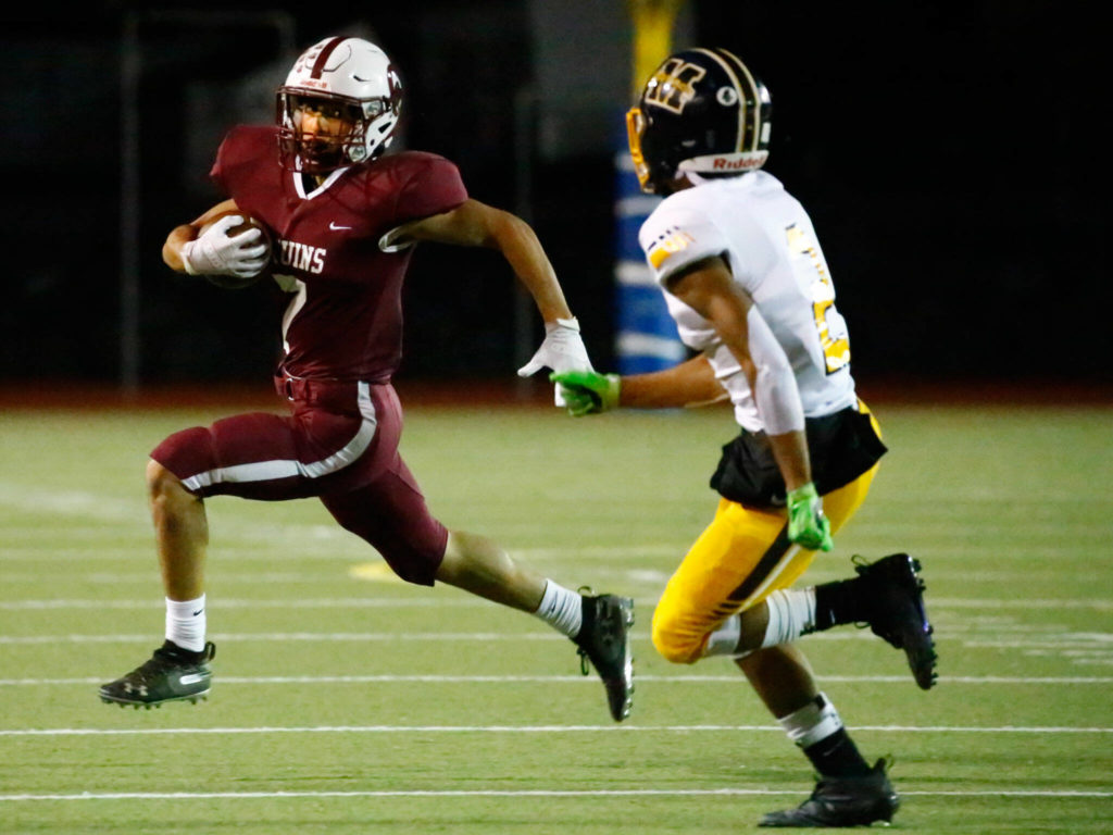 Cascade’s Zach Lopez, left, rushes with Mariners’ Macky James closing in on Sept. 10, 2021, at Everett Memorial Stadium. (Kevin Clark / The Herald)
