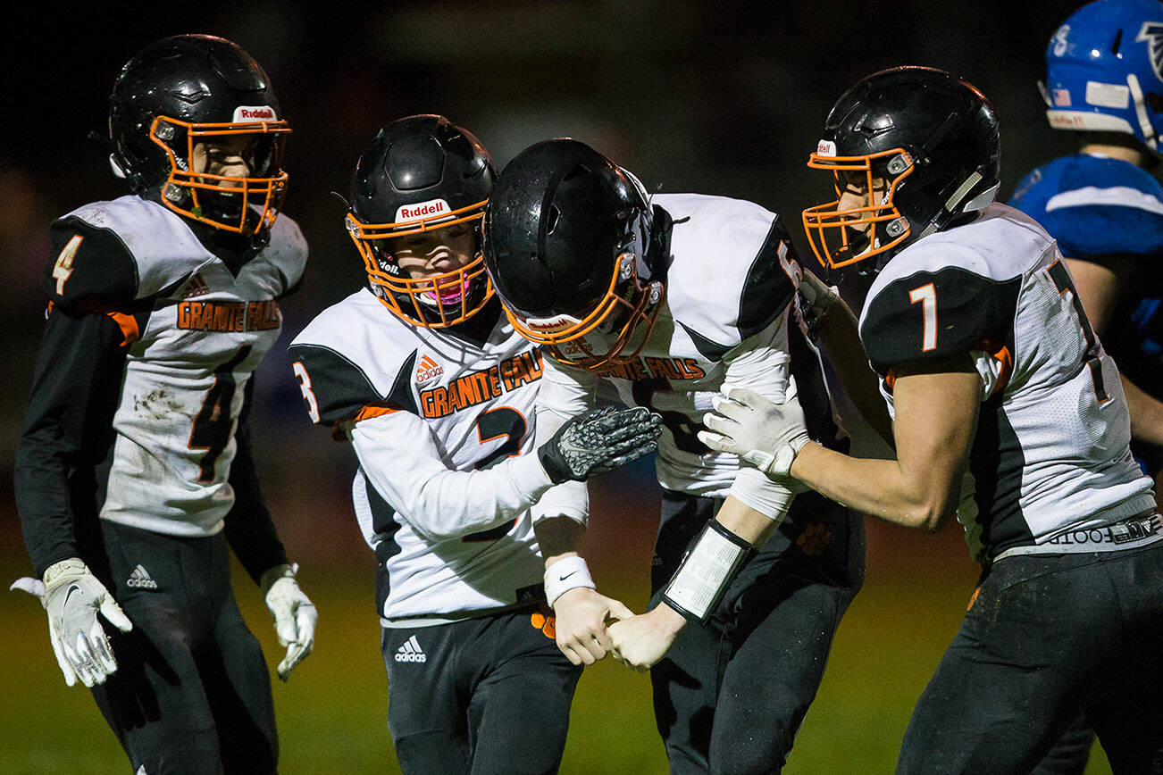 Granite Falls' Riley Hoople celebrates his touchdown with his teammates during the game against South Whidbey on Friday, Oct. 29, 2021 in Langley, Wa. (Olivia Vanni / The Herald)