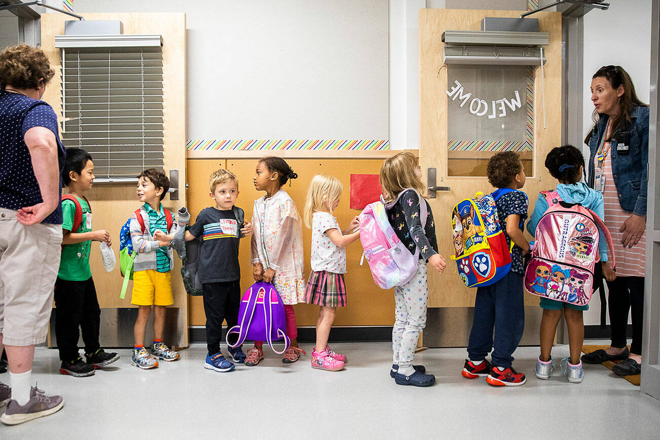 Kindergarteners from around the school district wait to change classrooms at Woodside Elementary School during Everett Ready, a program that helps kindergarteners get familiar with school routines on Friday, Aug. 26, 2022, near Everett, Washington. (Olivia Vanni / The Herald)