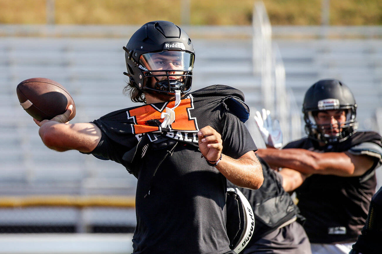 Blake Springer draws back for a pass during practice at Monroe High School Tuesday afternoon in Monroe, Washington on August 30, 2022.  (Kevin Clark / The Herald)