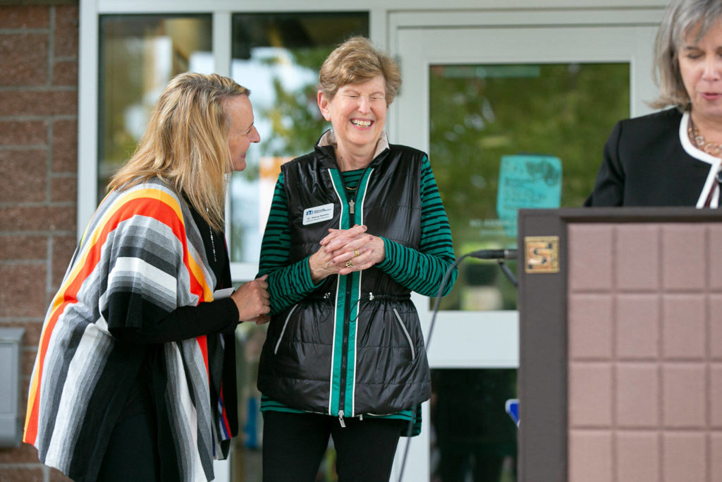 Assistant Superintendent Dana Geaslen, left, laughs with School Board Director Dr. Nancy Katims after Katims cut the ceremonial ribbon for the new school health center at Meadowdale High School on Wednesday, in Lynnwood. (Ryan Berry / The Herald)
