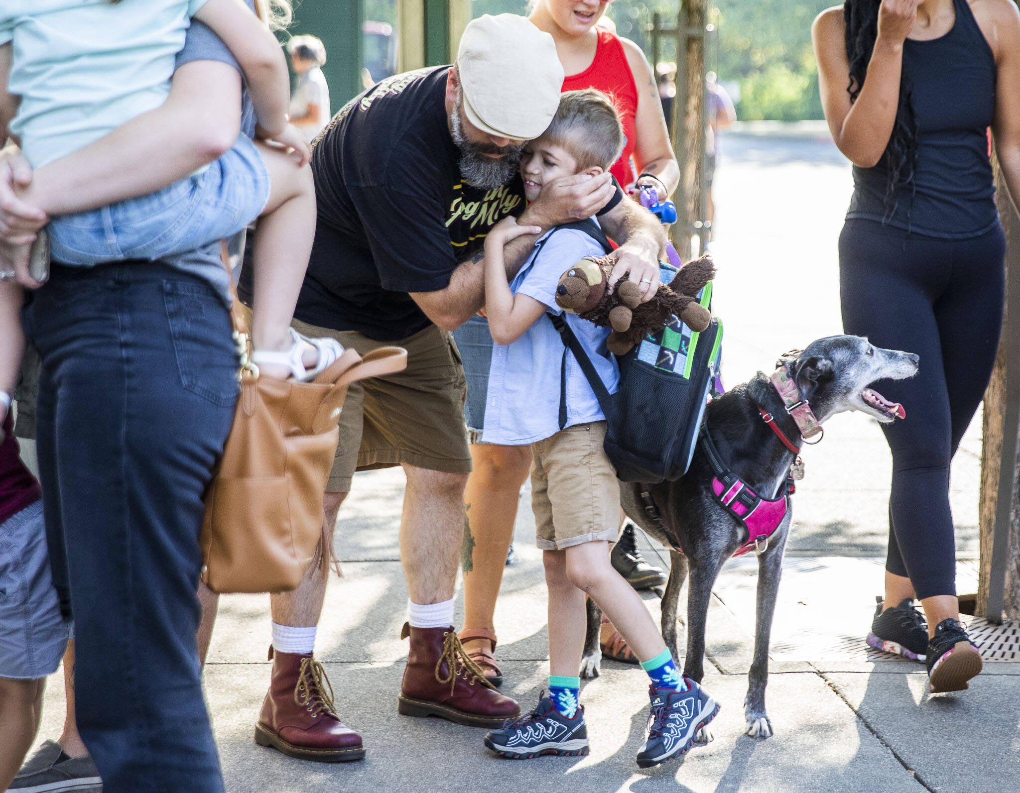 John Beckett, left, hugs his son Thomas, 8, before he heads into school for his first day of 3rd grade at Highland Elementary on Wednesday, in Lake Stevens. (Olivia Vanni / The Herald)