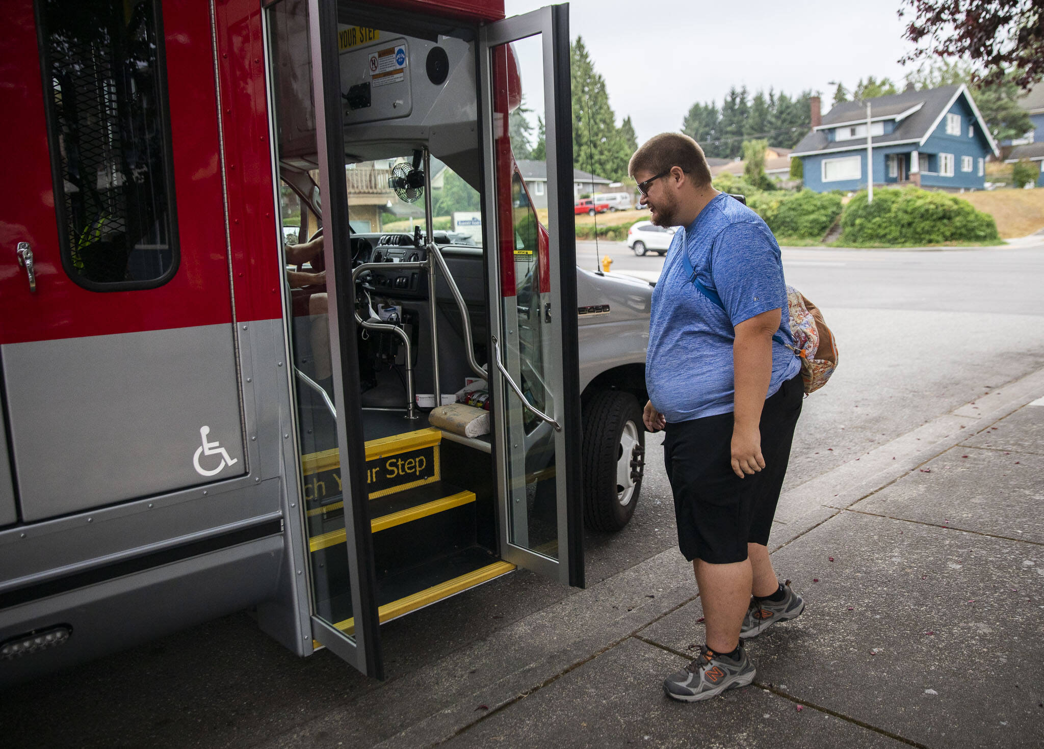 Doug Wennerberg boards an Everett Transit paratranist bus Thursday in Everett. He has autism and relies on family and friends for rides, and takes paratransit when they are not available. (Olivia Vanni / The Herald)