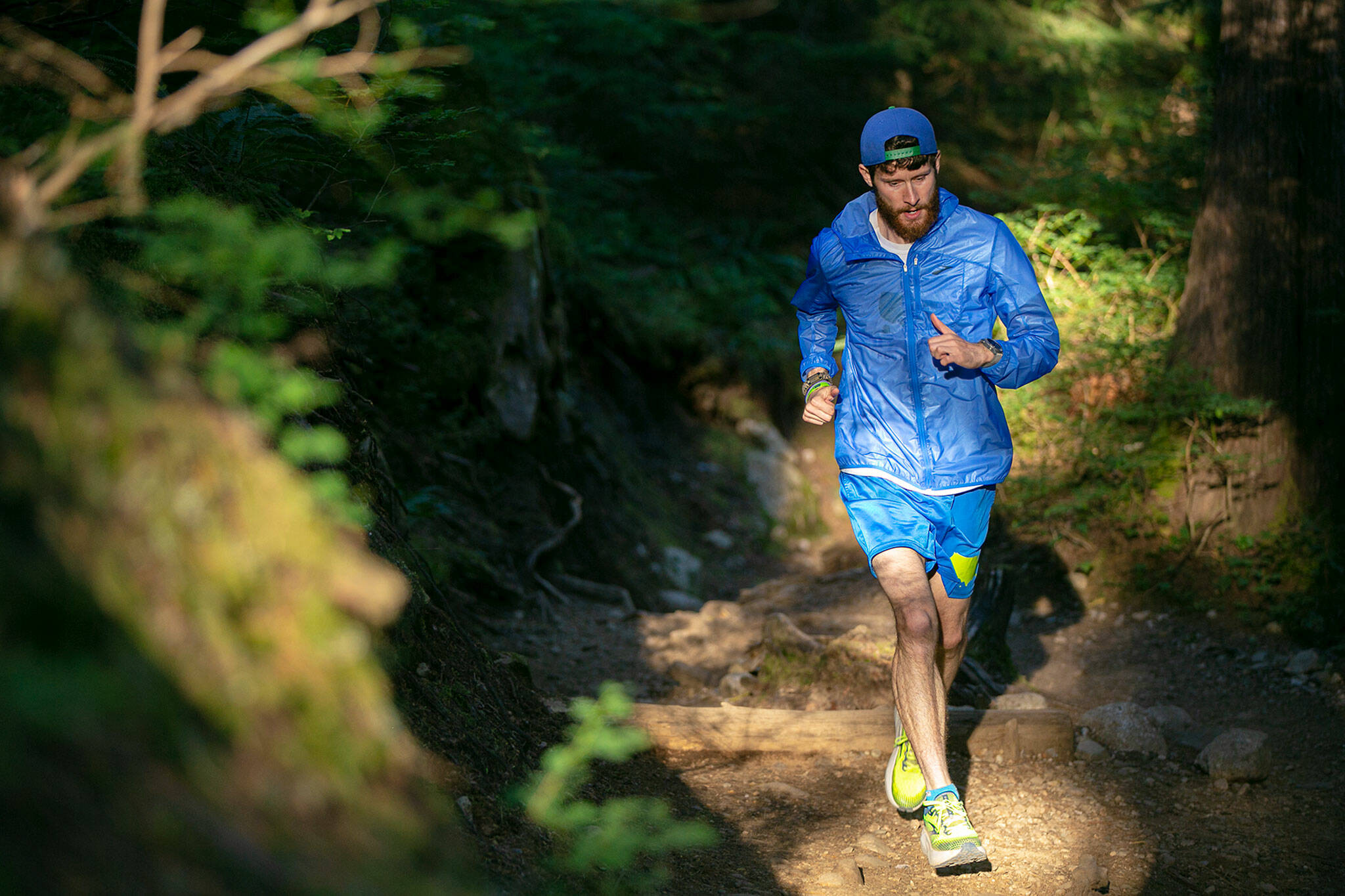 Greg Nance runs in the morning light up a trail on Tuesday, at the Mount Pilchuck Trailhead near Verlot. (Ryan Berry / The Herald)