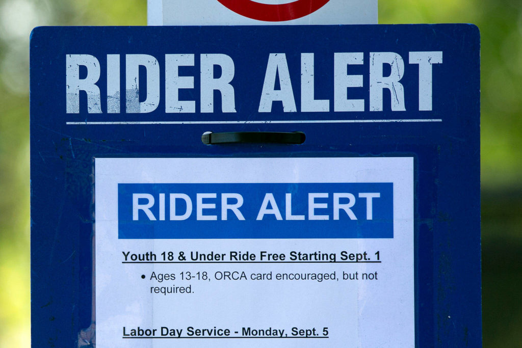 A rider alert is posted informing the public that people 18 and younger ride free as of Thursday, at Everett Station in Everett. (Ryan Berry / The Herald) 
