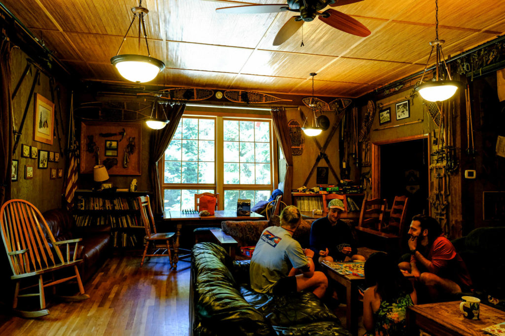 PCT thru hikers Jedi, Cuppa, Shin Splints and Genie play Catan Universe at Washington Alpine Club’s Guye Cabin. (Taylor Goebel / The Herald)
