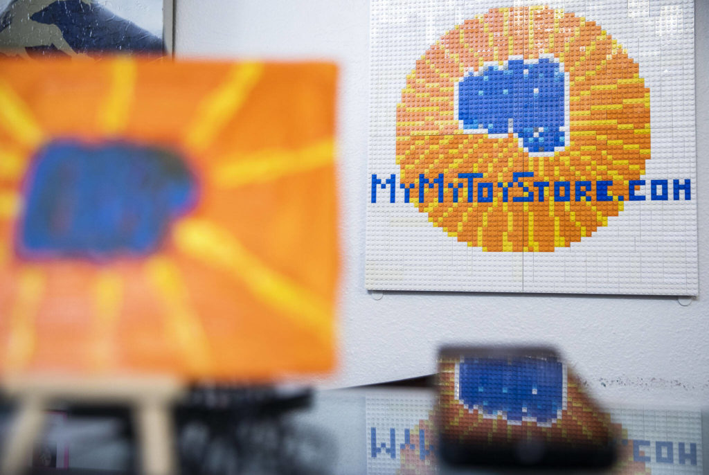 A lego mosaic of the MyMyToyStore.com logo hangs on the wall on Sept. 6, in Everett. (Olivia Vanni / The Herald)
