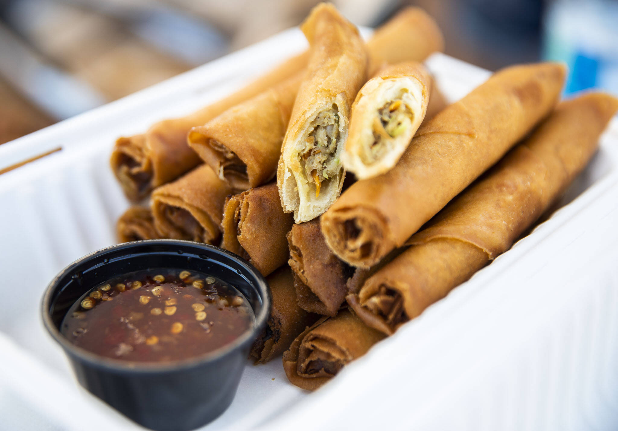 Wrap ’n’ Roll’s lumpia with a sweet and spicy chili sauce at the Monroe Farmers Market. (Olivia Vanni / The Herald)