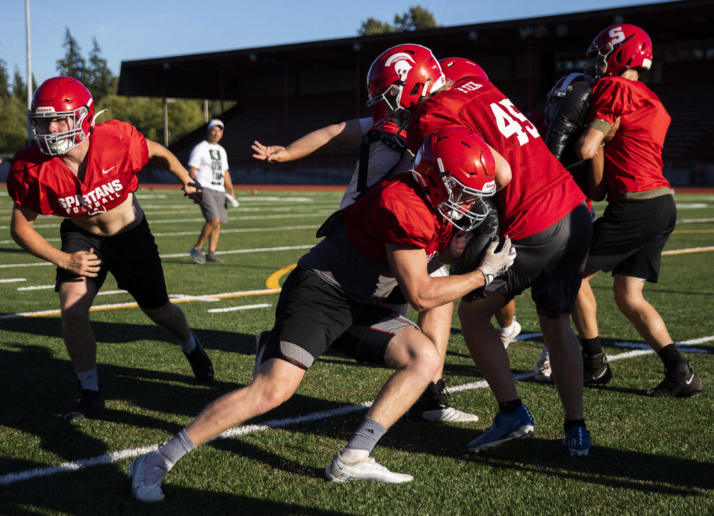 Stanwood’s Caden Caldero hits teammate Eli Fleck during practice Monday in Stanwood. The Spartans face Lakewood in a non-league game Friday. (Olivia Vanni / The Herald)
