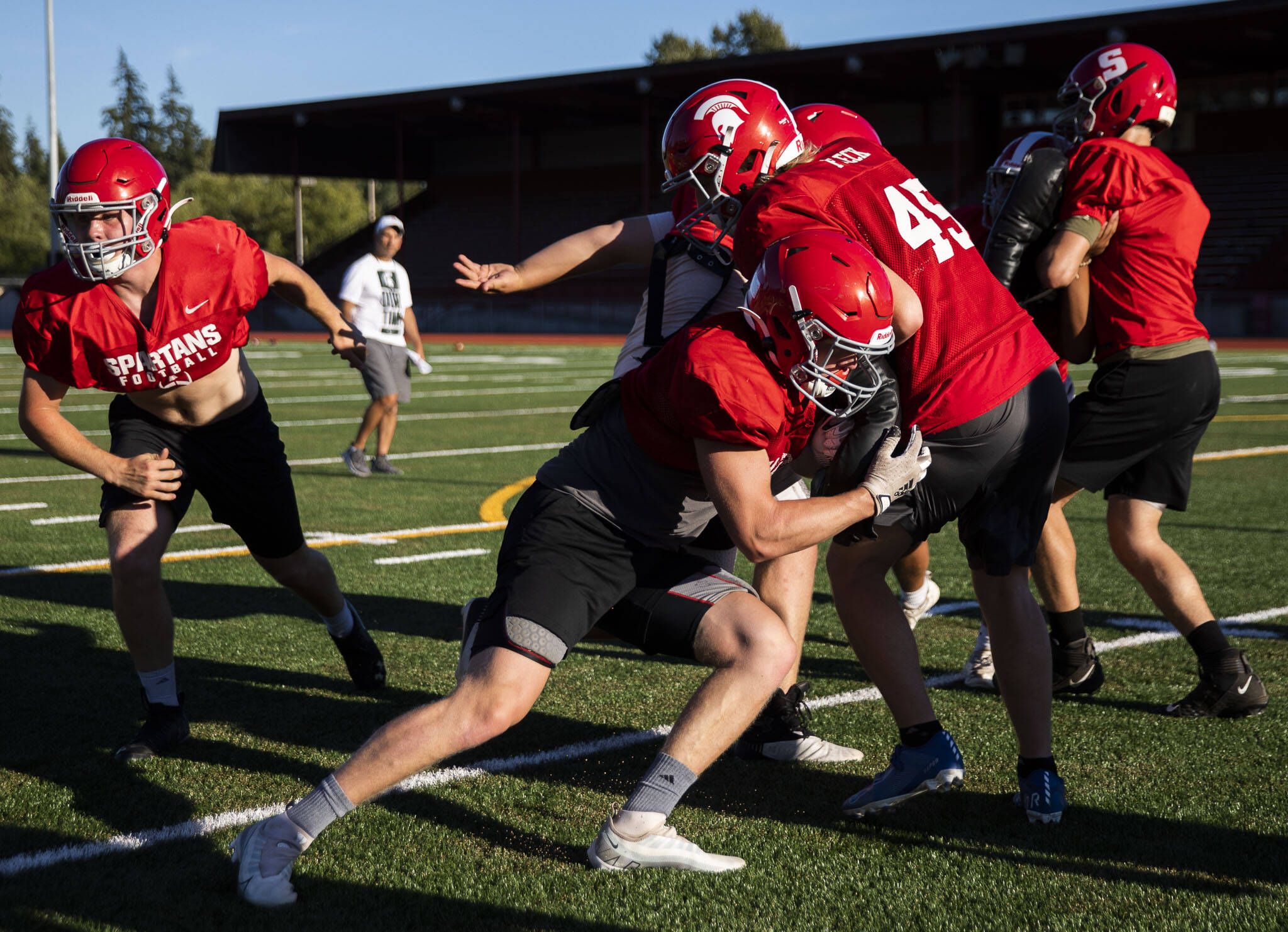 Stanwood’s Caden Caldero hits teammate Eli Fleck during practice Monday in Stanwood. The Spartans face Lakewood in a non-league game Friday. (Olivia Vanni / The Herald)