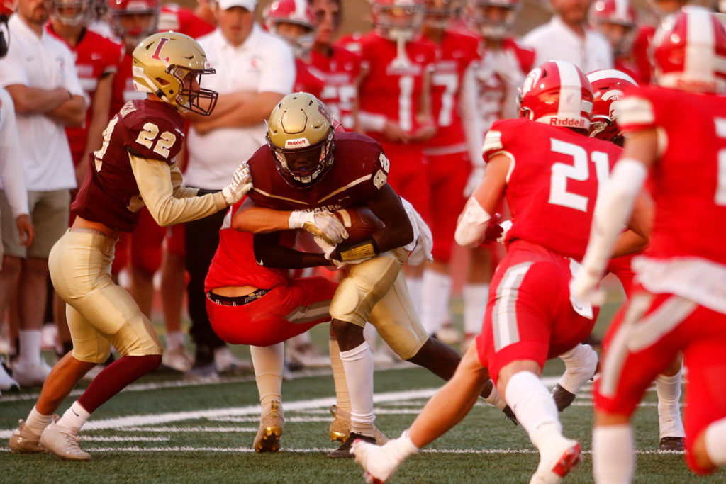 Lakewood’s Bakary Sonco plows forward for extra yards on a reception against Stanwood on Friday, Sep. 2, 2022, at Lakewood High School in Arlington, Washington. (Ryan Berry / The Herald)
