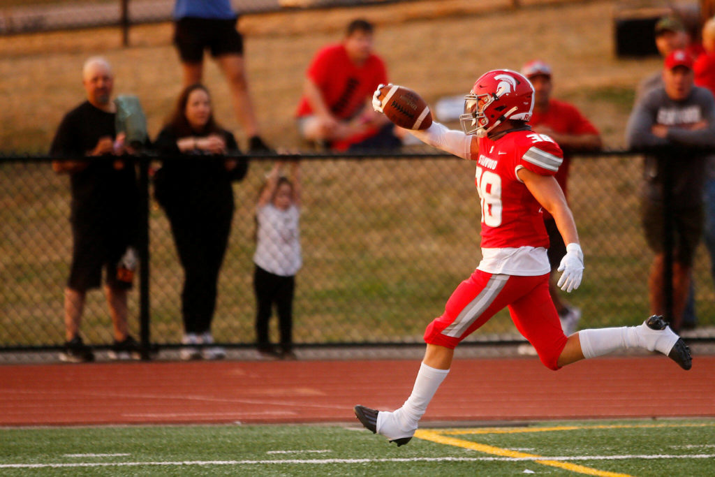 Stanwood’s Carson Beckt celebrates after scoring the first touchdown of the season against Lakewood on Friday, Sep. 2, 2022, at Lakewood High School in Arlington, Washington. (Ryan Berry / The Herald)
