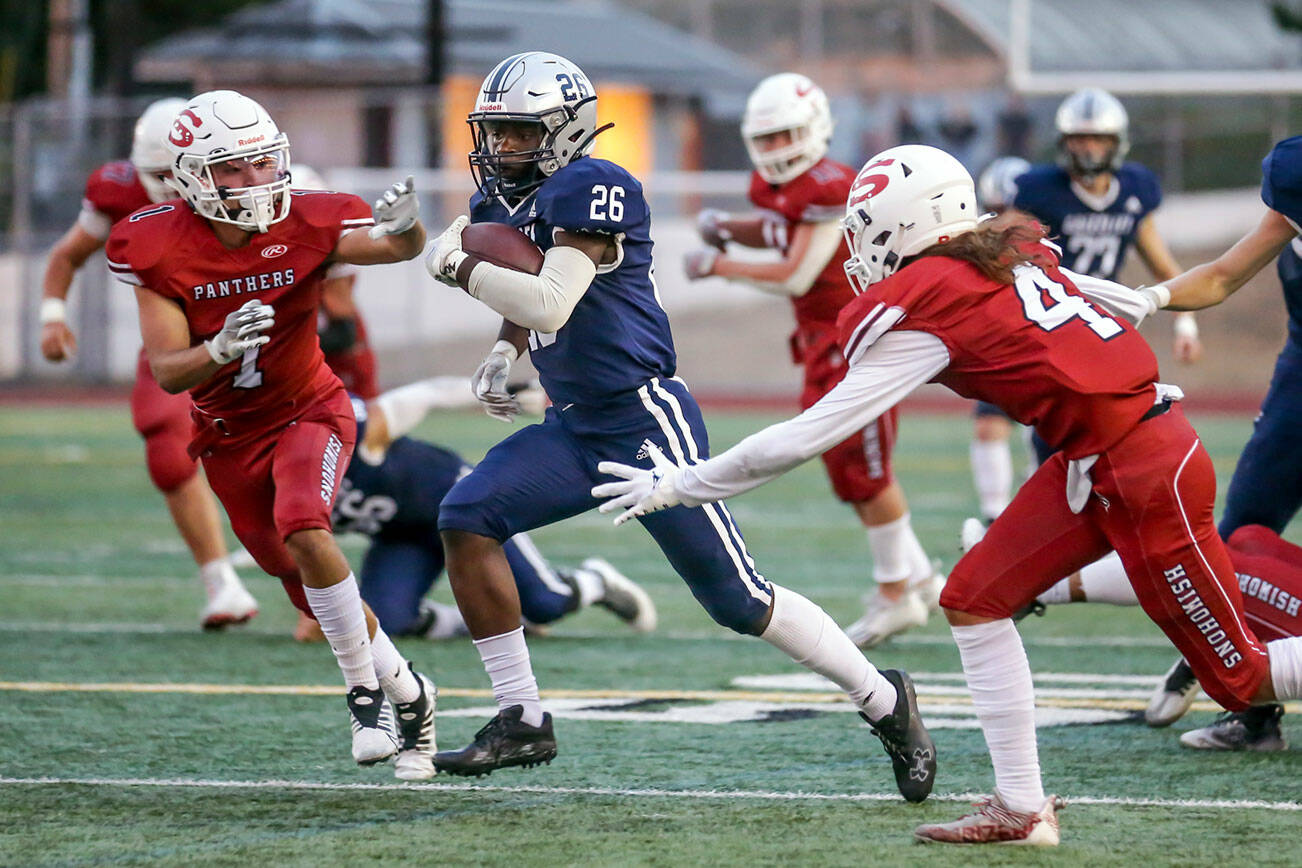 Glacier Peak’s Christian Bonshe rushes for yardage with Snohomish’s defense closing Friday night at Snohomish High School in Snohomish, Washington on September 2, 2022.  Glacier Peak led 28-0 at the half. (Kevin Clark / The Herald)