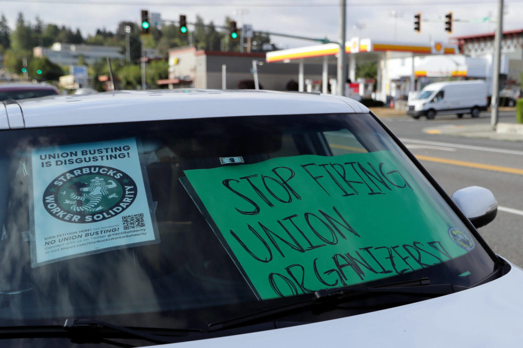 Signs decorate a windshield Monday morning during a “sip in” at Starbucks for union solidarity in Everett. (Kevin Clark / The Herald) 

