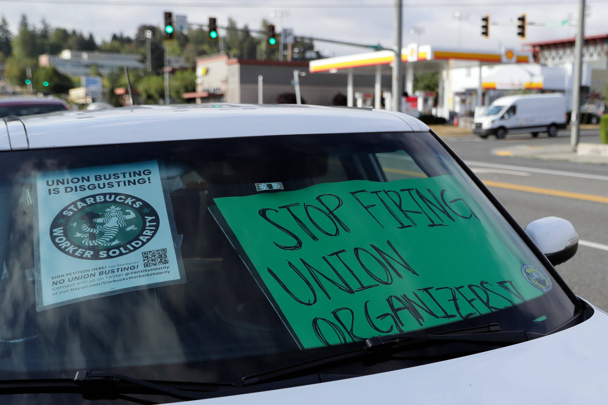 Signs decorate a windshield Monday morning during a “sip in” at Starbucks for union solidarity in Everett. (Kevin Clark / The Herald)