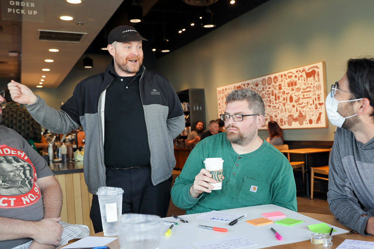 Tom Bosserman, left to right, Cornelius Ersoz and Nick Watkin Monday morning during a “sip in” at Starbucks for union solidarity in Everett, Washington on August 5, 2022.  (Kevin Clark / The Herald)