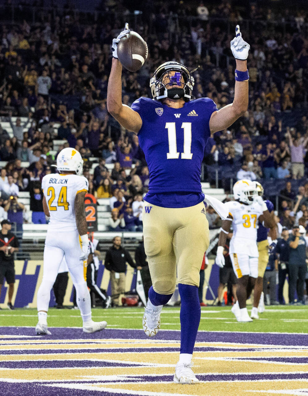 Washington’s Jalen McMillan scores on a touchdown pass from Michael Penix Jr. during the third quarter of a game against Kent State on Saturday in Seattle. (Dean Rutz/The Seattle Times via AP)