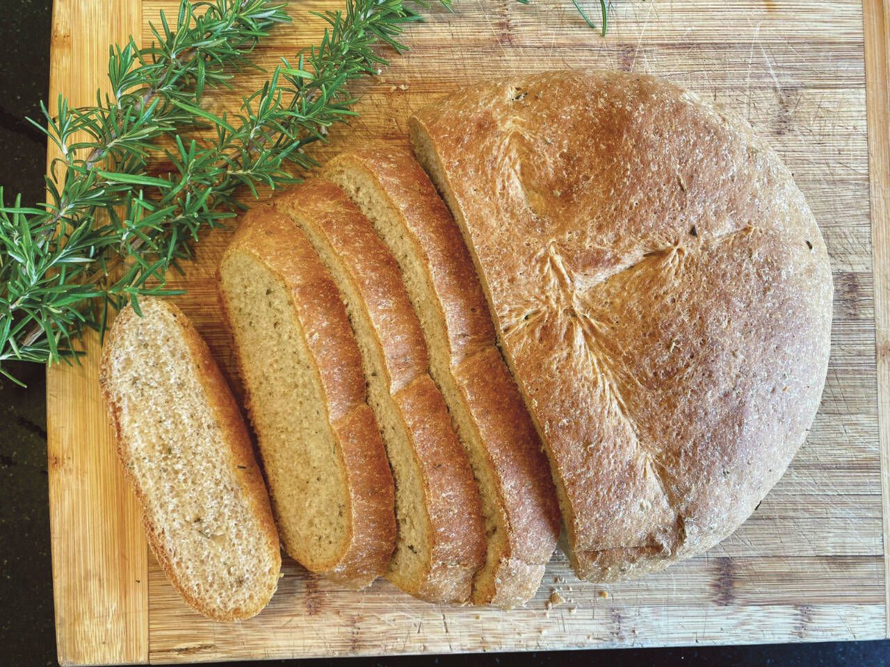 This loaf of rosemary bread was over-proofed, due to a warm kitchen, but luckily was still delicious with a dinner of roast beef, carrots and potatoes. (Photo by Tressa Dale)