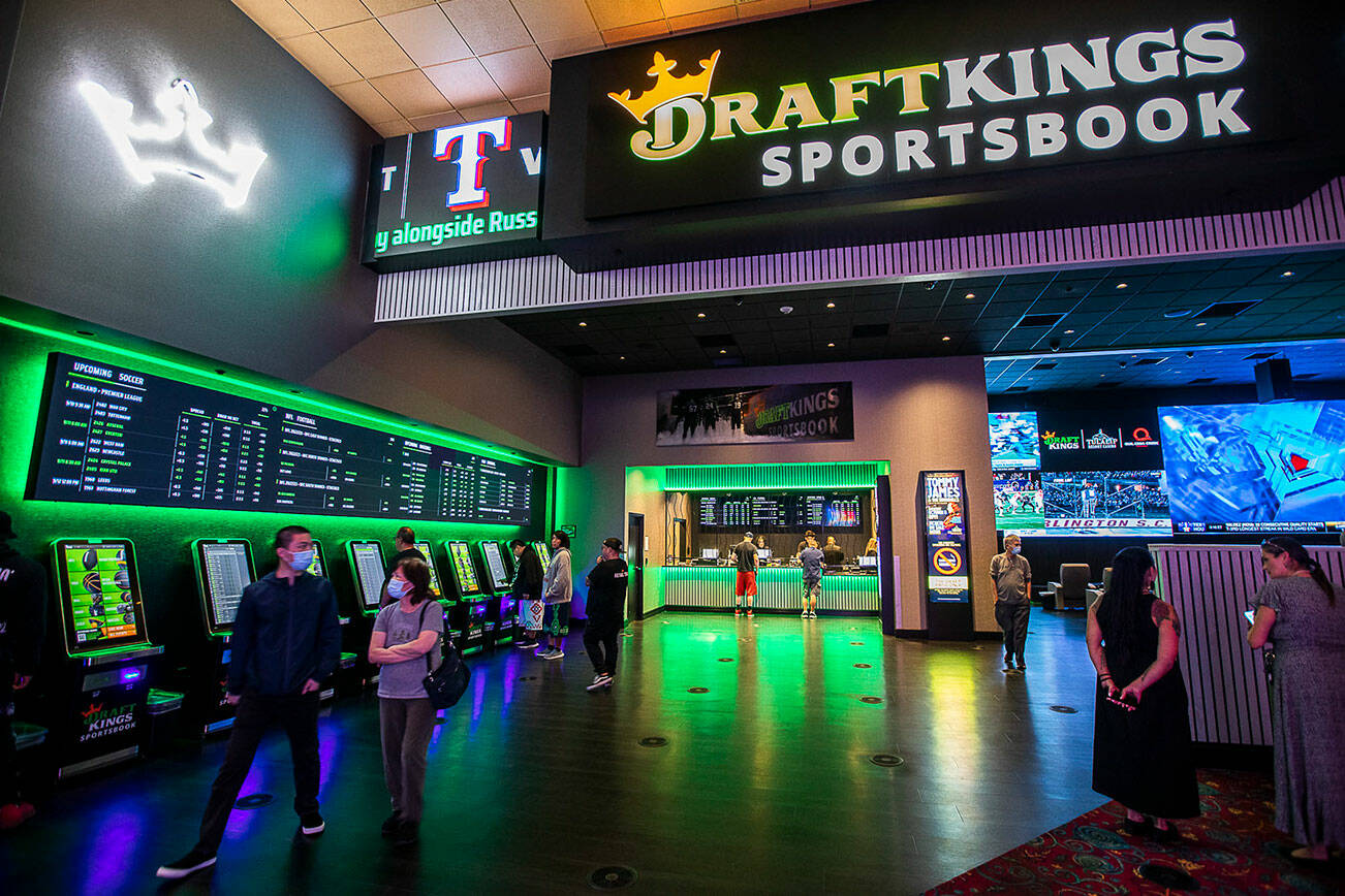 People wander through the DraftKings Sportsbook during the soft opening at the Tualip Casino on Tuesday, Sept. 6, 2022 in Tulalip, Washington. (Olivia Vanni / The Herald)