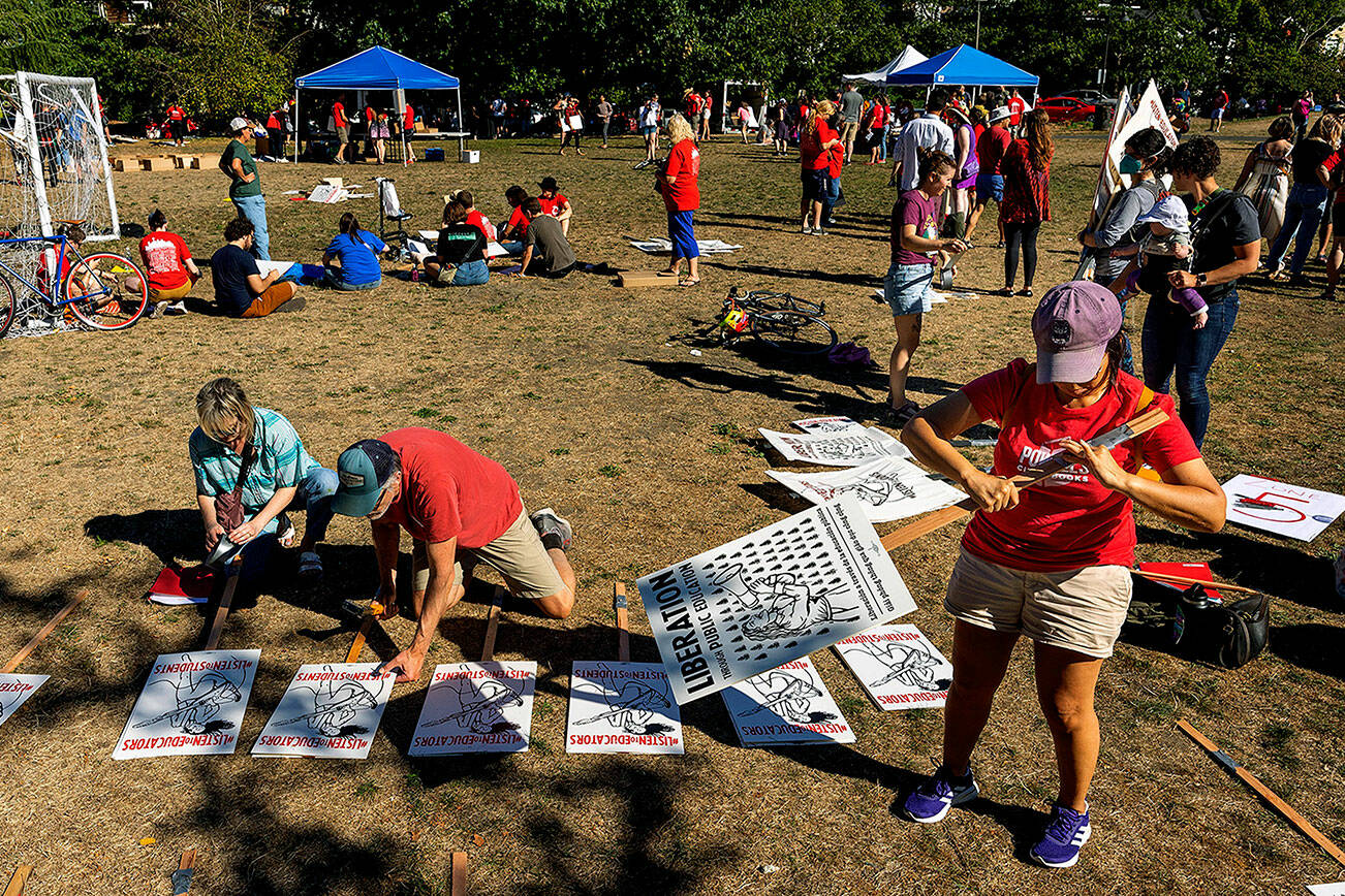 Seattle teachers make signs at Judkins Park Monday, Sept. 5, 2022 in advance of a possible strike this week. Teachers in Seattle have overwhelmingly voted to authorize a strike as contract talks continue on the eve of the new school year. Seattle Education Association President Jennifer Matter announced Tuesday that 95% of ballots returned by the union's membership favored going on strike absent an agreement with Seattle Public Schools. (Dean Rutz/The Seattle Times via AP)