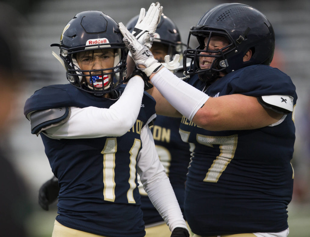Arlington’s Wyatt Tilton (right) celebrate’s with teammate Trenton Lamie during a game against Oak Harbor on Sept. 10, 2021, in Arlington. The Eagles take on Marysville Getchell in a Wesco 3A North matchup Friday. (Olivia Vanni / The Herald)
