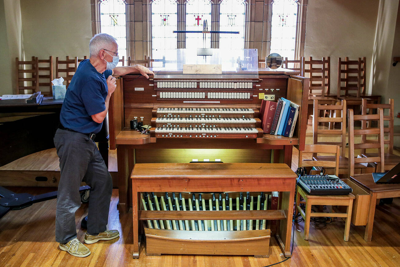 David Spring explains possible plans available for the church’s organ Wednesday afternoon at Trinity Episcopal in Everett, Washington on September 7, 2022. The organ is  the second largest organ in the city and the church is raising money to rebuild the Balcom and Vaughan pipe organ which has been in place since 1971.(Kevin Clark / The Herald)