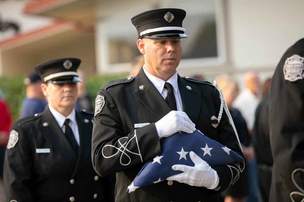 The colors are presented during a ceremony to commemorate the 21st anniversary of the September 11 terrorist attacks on the U.S. on Sep. 11, 2022, outside South County Fire Station 17 in downtown Edmonds, Washington. (Ryan Berry / The Herald)
