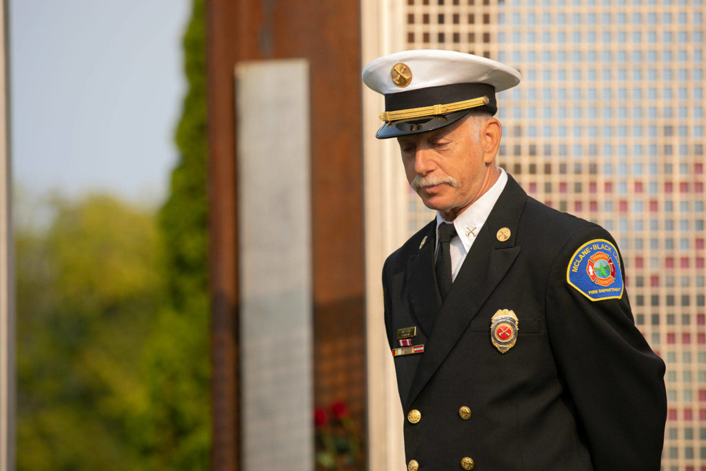 Former New York firefighter Andy Speier speaks to a crowd during a ceremony to commemorate the 21st anniversary of the September 11 terrorist attacks on the U.S. on Sep. 11, 2022, outside South County Fire Station 17 in downtown Edmonds, Washington. (Ryan Berry / The Herald)
