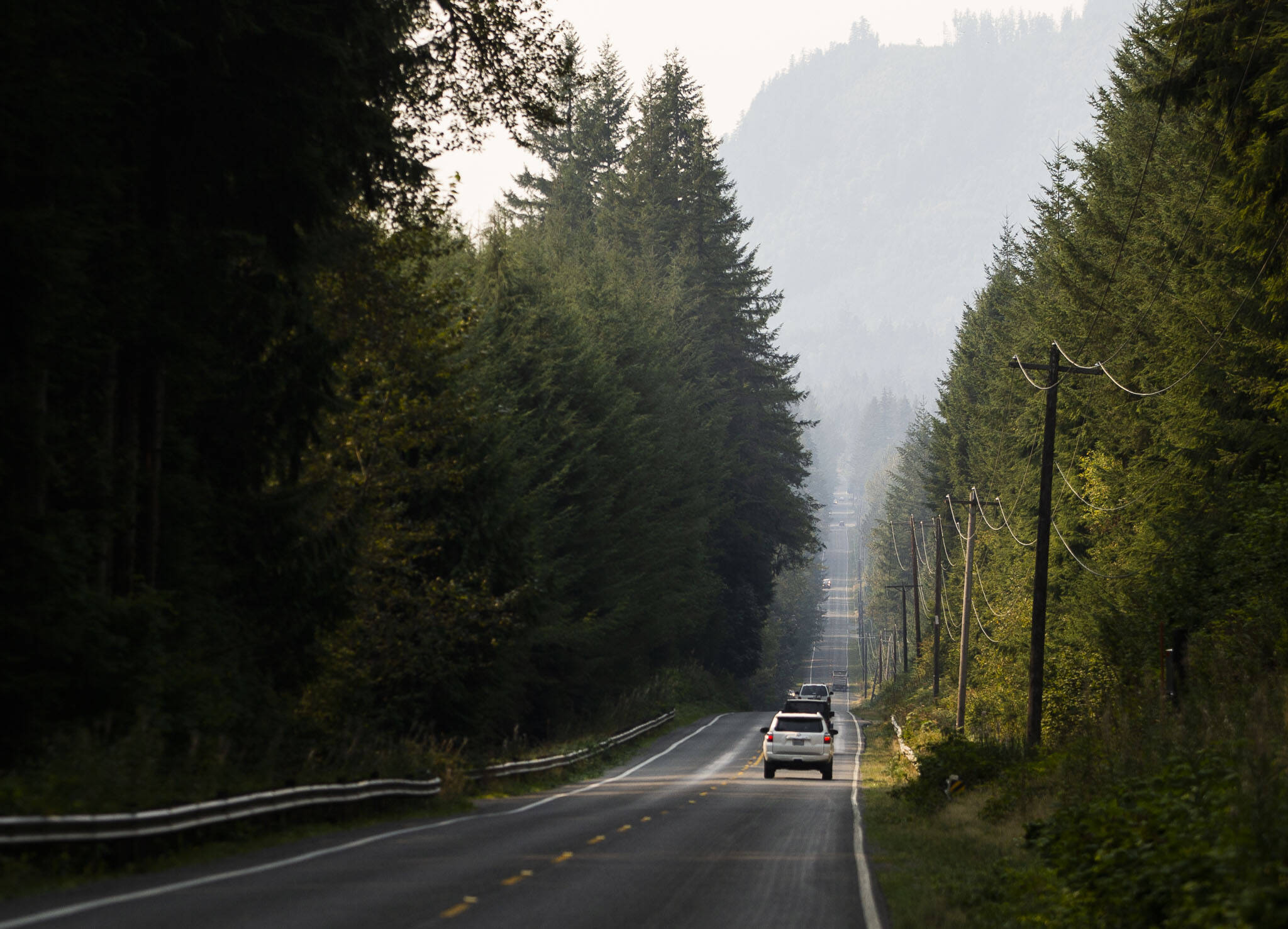 Cars drive along a smokey Mountain Loop Highway on Friday, in Granite Falls. (Olivia Vanni / The Herald)