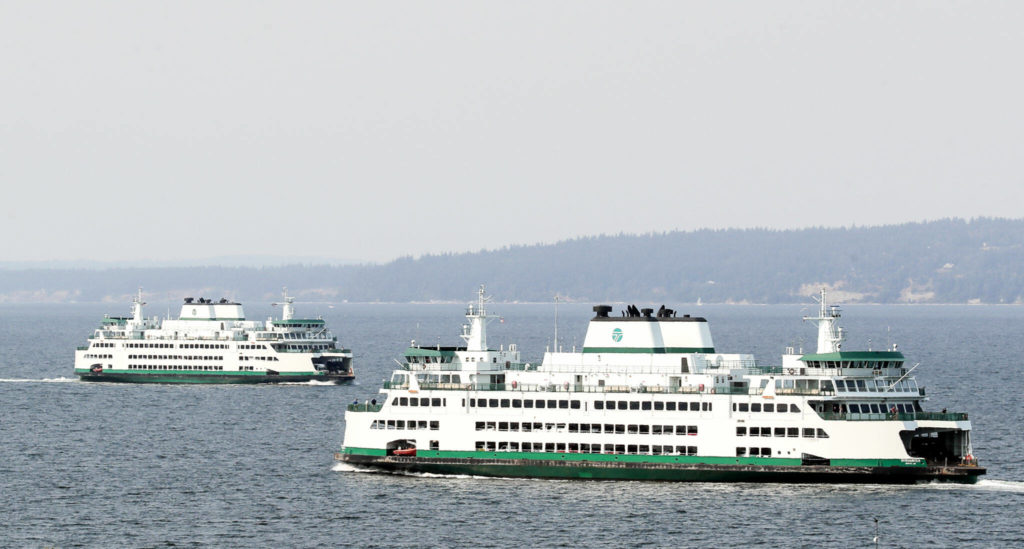 Ferries near Mukilteo on Friday cross path in the waters of Possession Sound through the smoke and haze of the Darrington wildfires. (Kevin Clark / The Herald) 
