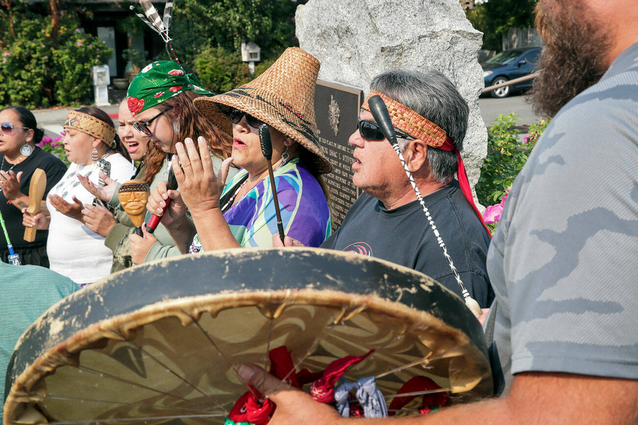 Members of the Tulalip Tribes perform a blessing and acknowledgement at the dedication of the replacement bronze plaque for the 1855 treaty between local tribes and the U.S. government in Mukilteo, Washington on September 9, 2022. (Kevin Clark / The Herald)