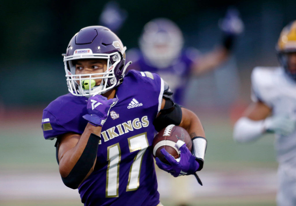 Limar bursts down the sideline for one of his three touchdowns. (Ryan Berry / The Herald)
