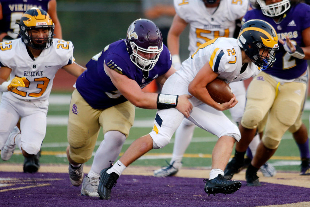 Bellevue’s Blake Teets weaves through the defense for a solid gain against Lake Stevens on Friday, Sep. 9, 2022, at Lake Stevens High School in Lake Stevens, Washington. (Ryan Berry / The Herald)
