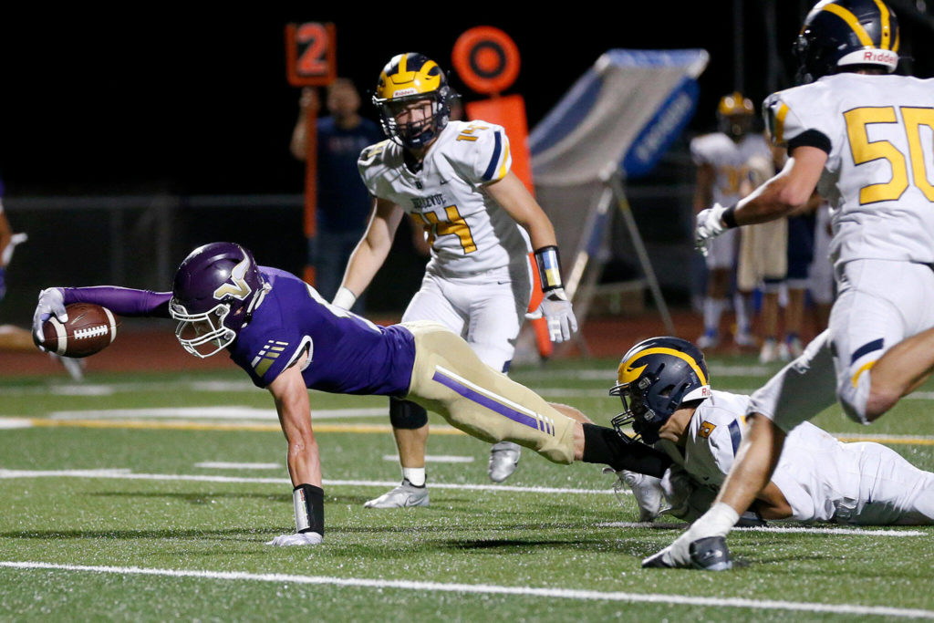 Lake Stevens receiver Cole Becker reaches across the goal line for a third-quarter touchdown. (Ryan Berry / The Herald)
