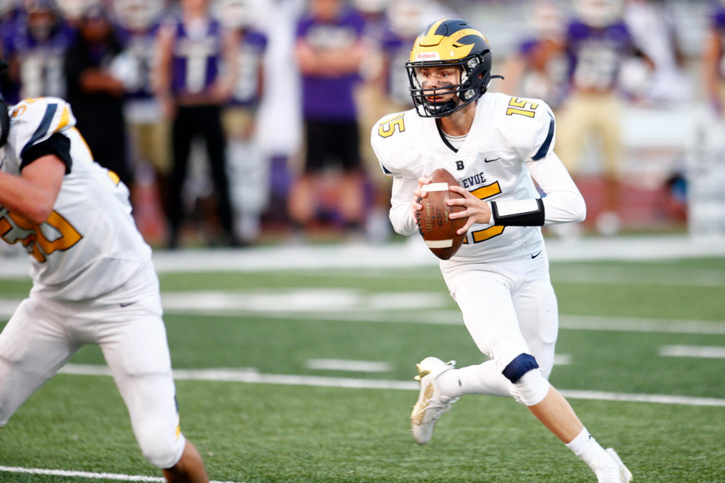 Bellevue’s Lucas Razore turns and looks for a receiver against Lake Stevens on Friday, Sep. 9, 2022, at Lake Stevens High School in Lake Stevens, Washington. (Ryan Berry / The Herald)
