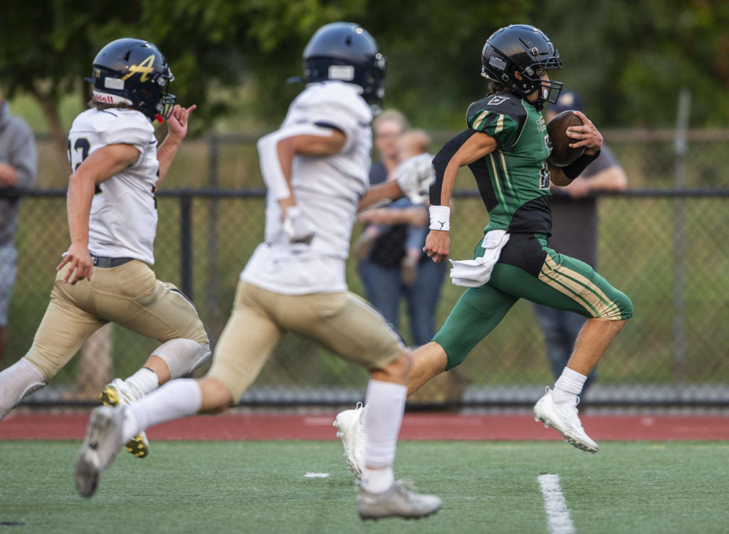 Marysville Getchell’s Carter Schmidt runs the ball down the field for a touchdown during the game against Arlington on Friday, Sept. 9, 2022 in Marysville, Washington. (Olivia Vanni / The Herald)
