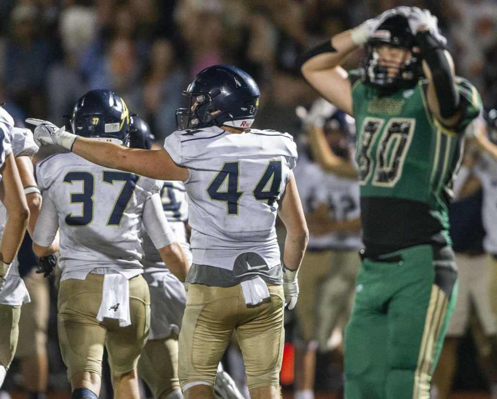 Arlington’s Spencer Fischer points to signal Arlington ball after a turnover during the game against Marysville Getchell on Friday, Sept. 9, 2022 in Marysville, Washington. (Olivia Vanni / The Herald)
