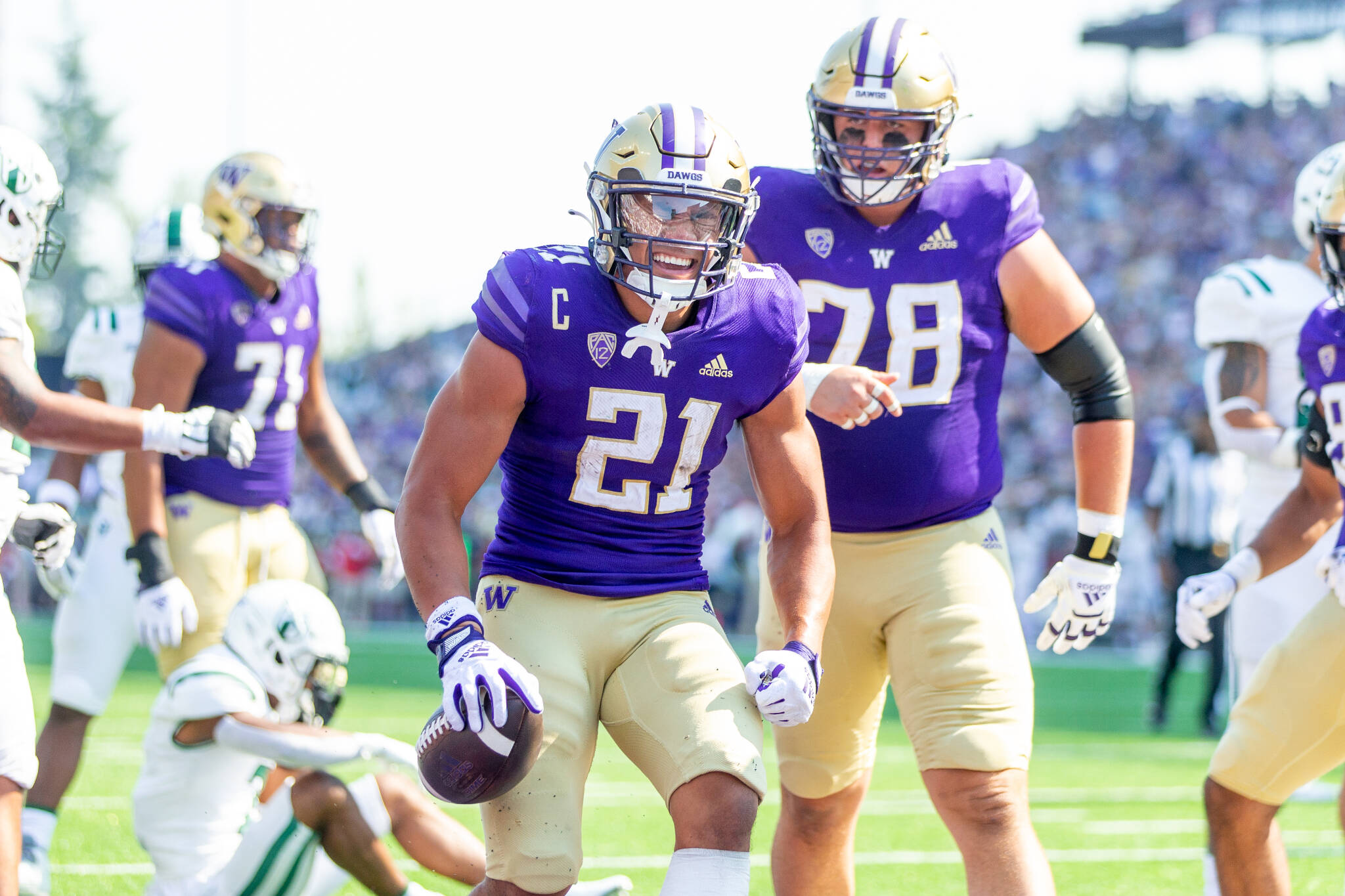Washington running back Wayne Taulapapa (21) celebrates a touchdown during a game against Portland State on Saturday afternoon in Seattle. (Scott Eklund/Red Box Pictures)