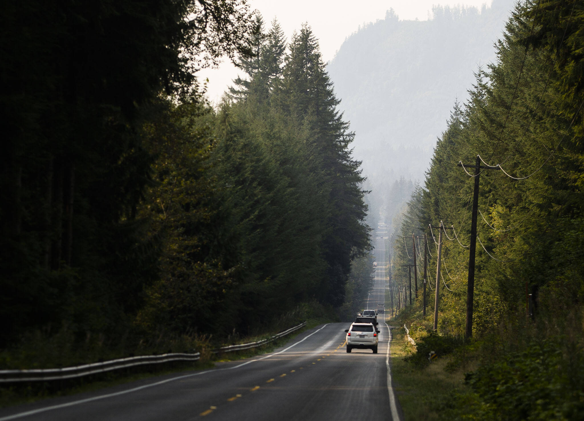 Cars drive along a smokey Mountain Loop Highway on Friday, Sept. 9, 2022 in Granite Falls, Washington. (Olivia Vanni / The Herald)