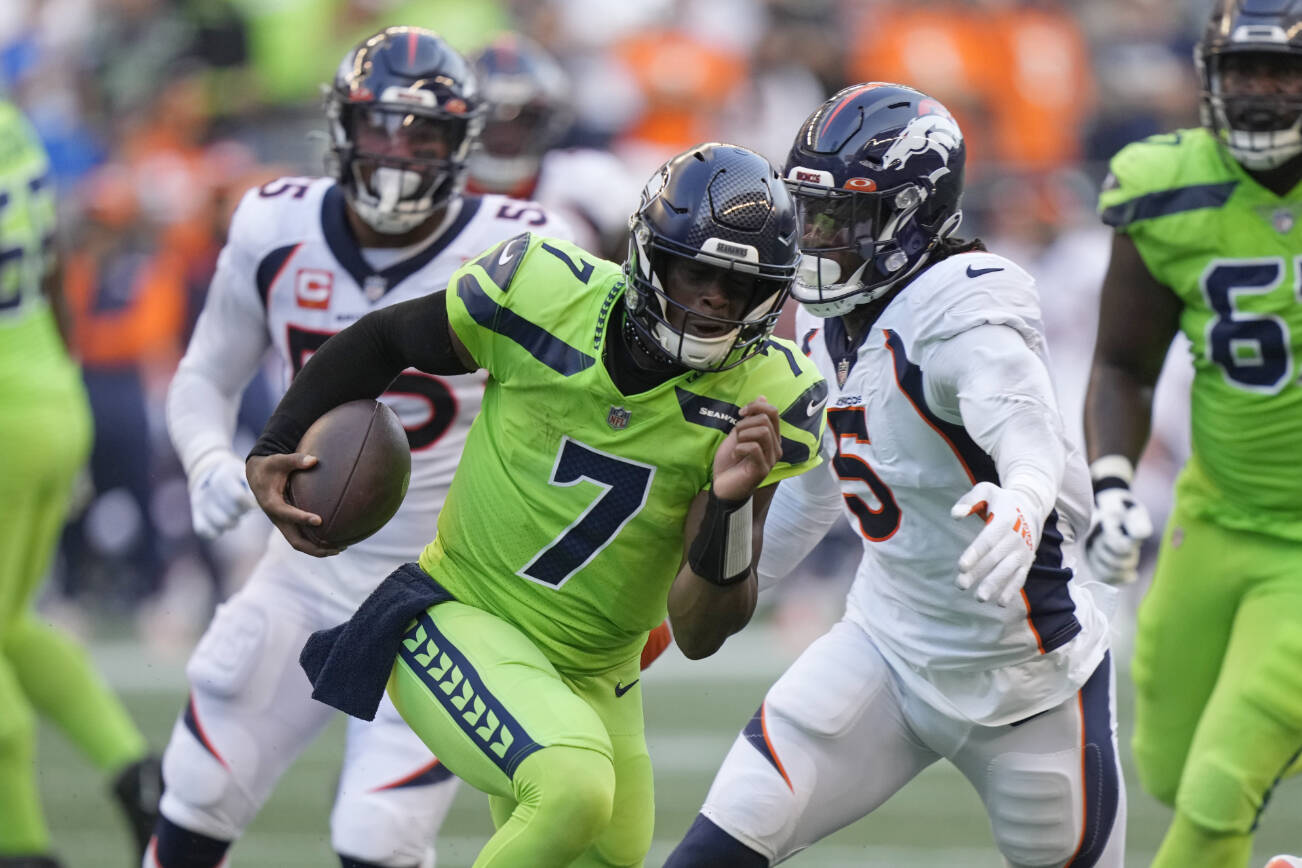 Seattle Seahawks quarterback Geno Smith (7) scrambles against the Denver Broncos during the first half of an NFL football game, Monday, Sept. 12, 2022, in Seattle. (AP Photo/Stephen Brashear)