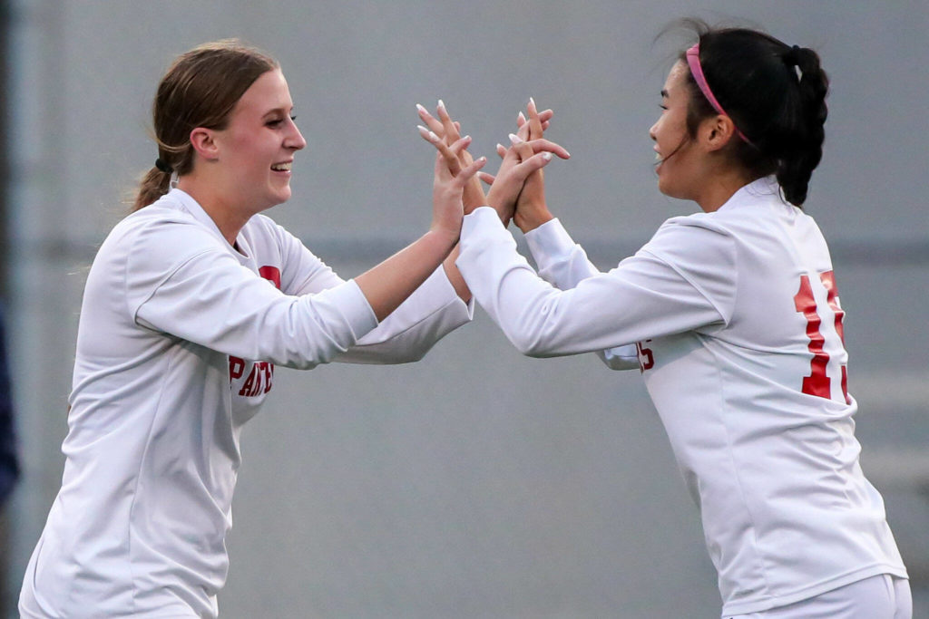 Snohomish’s Sara Rodgers, left, celebrates her second score Mak Kunz Tuesday evening in Everett, Washington on September 13, 2022. The Panthers defeated the Eagles 3-1. (Kevin Clark / The Herald)
