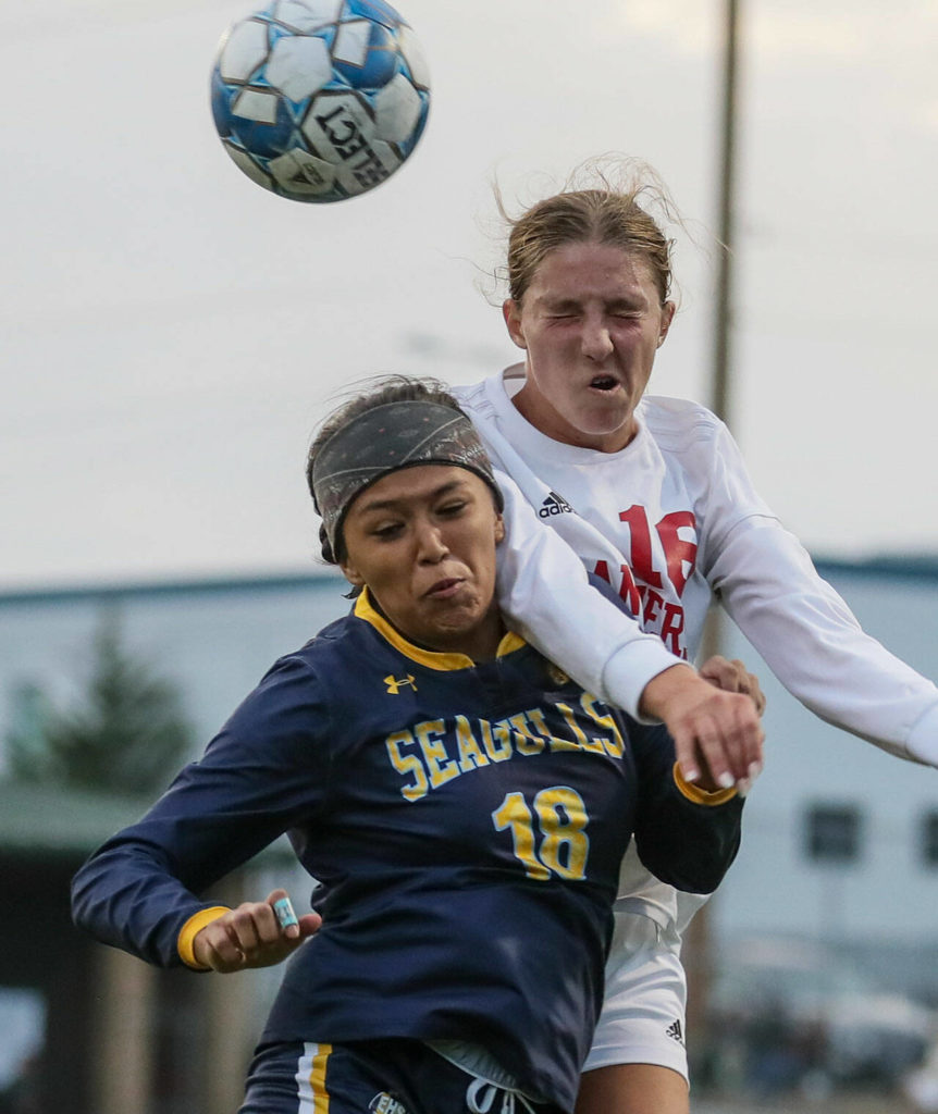 Everett’s Andrea Parrish, left, and Snohomish’s Brianna Ulrich jump to compete for a header Tuesday evening in Everett, Washington on September 13, 2022. The Panthers defeated the Eagles 3-1. (Kevin Clark / The Herald)
