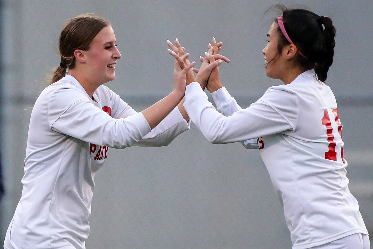 Snohomish's Sara Rodgers, left, celebrates her second score Mak Kunz Tuesday evening in Everett, Washington on September 13, 2022. The Panthers defeated the Eagles 3-1. (Kevin Clark / The Herald)